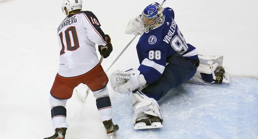Tampa Bay Lightning goaltender Andrei Vasilevskiy (88) blocks a shot as Columbus Blue Jackets center Alexander Wennberg (10) is in position for the rebound during the first period in game five of the first round of the 2020 Stanley Cup Playoffs at Scotiabank Arena.