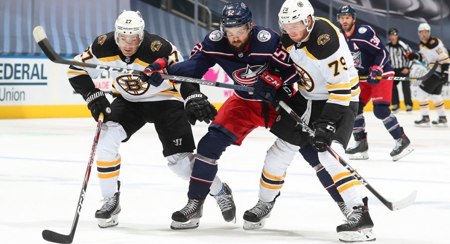 Emil Bemstrom tries to split the Boston Bruins' defense