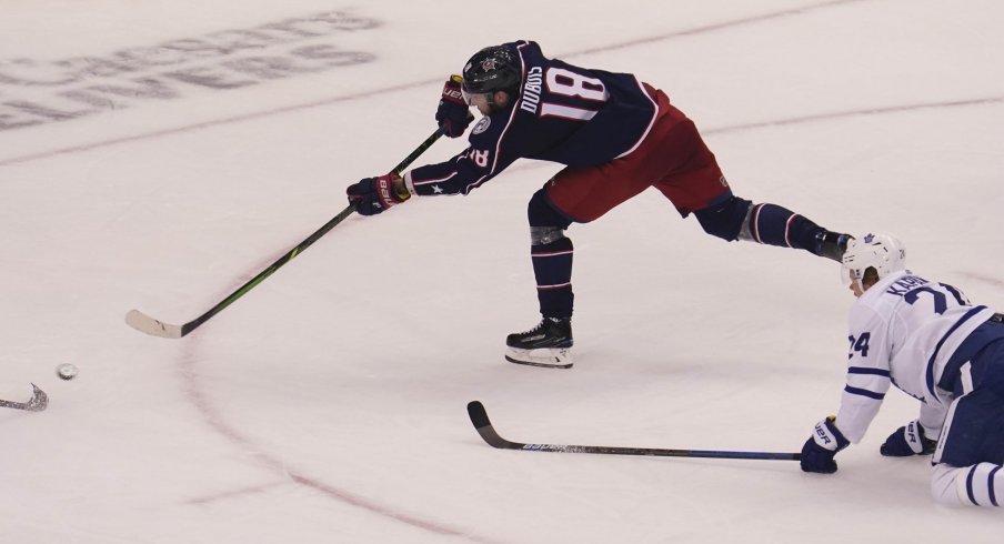 Aug 6, 2020; Toronto, Ontario, CAN; Columbus Blue Jackets forward Pierre-Luc Dubois (18) scores on this shot as Toronto Maple Leafs forward Kasperi Kapanen (24) looks on during the third period of Eastern Conference qualifications at Scotiabank Arena.