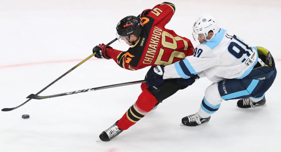 Blue Jackets prospect Yegor Chinakhov protecting the puck.