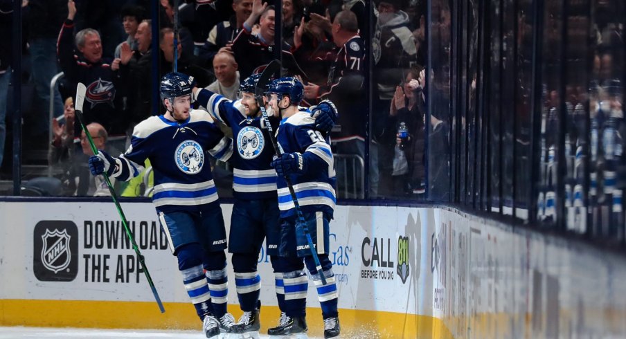 Feb 20, 2020; Columbus, Ohio, USA; Columbus Blue Jackets left wing Nick Foligno (middle) celebrates with teammate center Pierre-Luc Dubois (left) and right wing Oliver Bjorkstrand (right) after scoring a goal against the Philadelphia Flyers in the first period at Nationwide Arena.