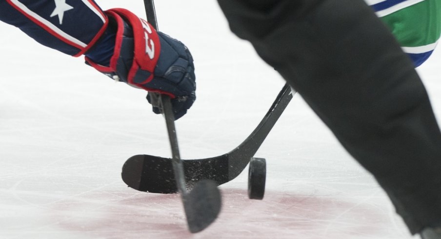 A detail view of a second period face off between the Columbus Blue Jackets and Vancouver Canucks at Nationwide Arena. 