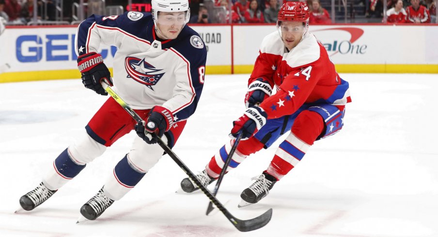 Dec 27, 2019; Washington, District of Columbia, USA; Columbus Blue Jackets defenseman Zach Werenski (8) skates with the puck as Washington Capitals right wing Richard Panik (14) defends in the first period at Capital One Arena.