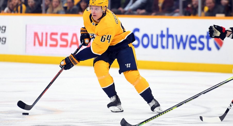 Feb 25, 2020; Nashville, Tennessee, USA; Nashville Predators center Mikael Granlund (64) skates with the puck during the first period against the Ottawa Senators at Bridgestone Arena.