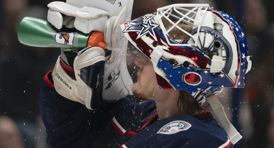 Columbus Blue Jackets goaltender Joonas Korpisalo hydrates during a stoppage in play at Nationwide Arena.