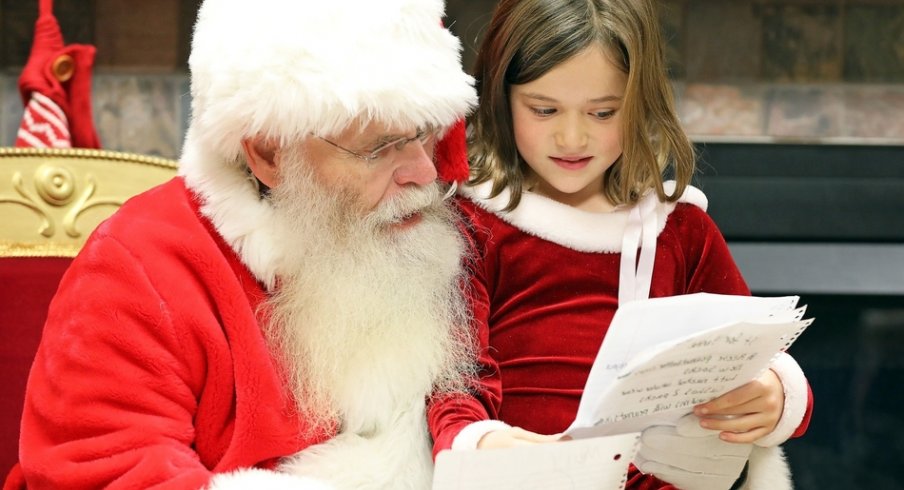 Lacie Shuff, 8, of Altoona reviews her wish list with Santa during Breakfast with Santa on Saturday, Dec. 1, 2018 at the Youth Center in Doanes Park in Pleasant Hill.