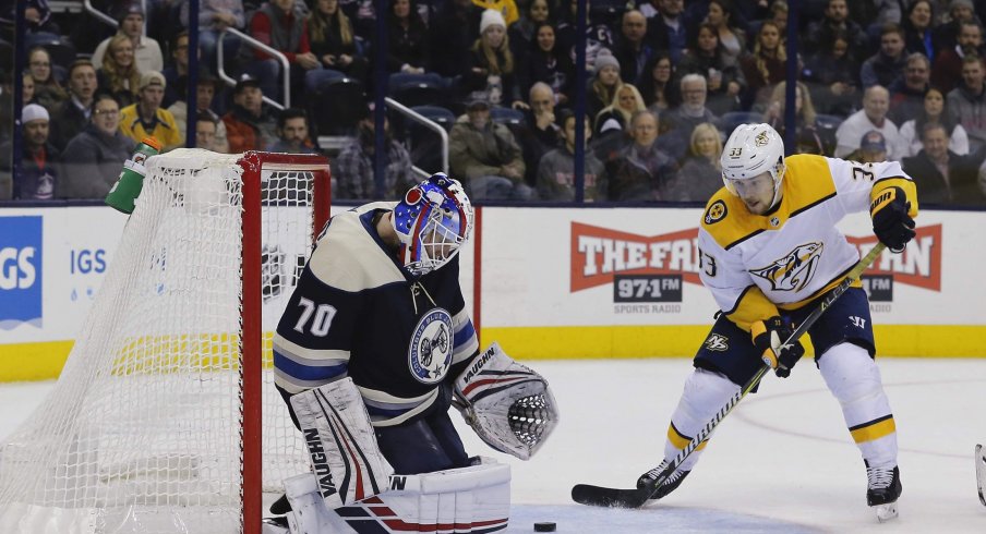 Jan 10, 2019; Columbus, OH, USA; Columbus Blue Jackets goalie Joonas Korpisalo (70) makes a save as Nashville Predators right wing Viktor Arvidsson (33) looks for the rebound during the third period at Nationwide Arena.