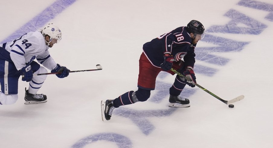 Columbus Blue Jackets forward Pierre-Luc Dubois (18) gets past Toronto Maple Leafs defenseman Morgan Rielly (44) to score the winning goal during overtime of Eastern Conference qualifications at Scotiabank Arena