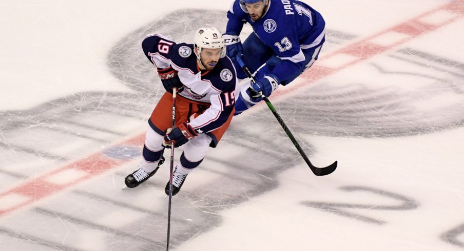 Aug 13, 2020; Toronto, Ontario, CAN; Columbus Blue Jackets center Liam Foudy (19) skates with the puck away from Tampa Bay Lightning center Cedric Paquette (13) during the first period in game two of the first round of the 2020 Stanley Cup Playoffs at Scotiabank Arena.