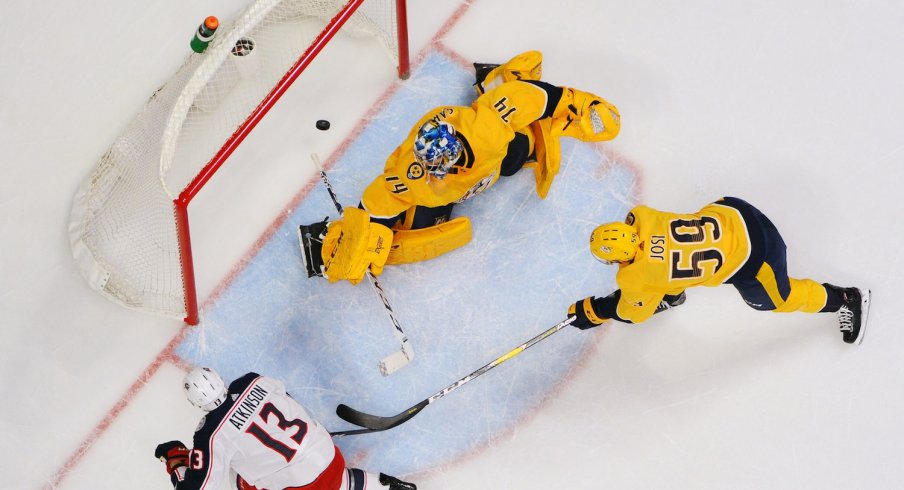 Columbus Blue Jackets forward Cam Atkinson scores against Nashville Predators goaltender Juuse Saros during a game at Bridgestone Arena.