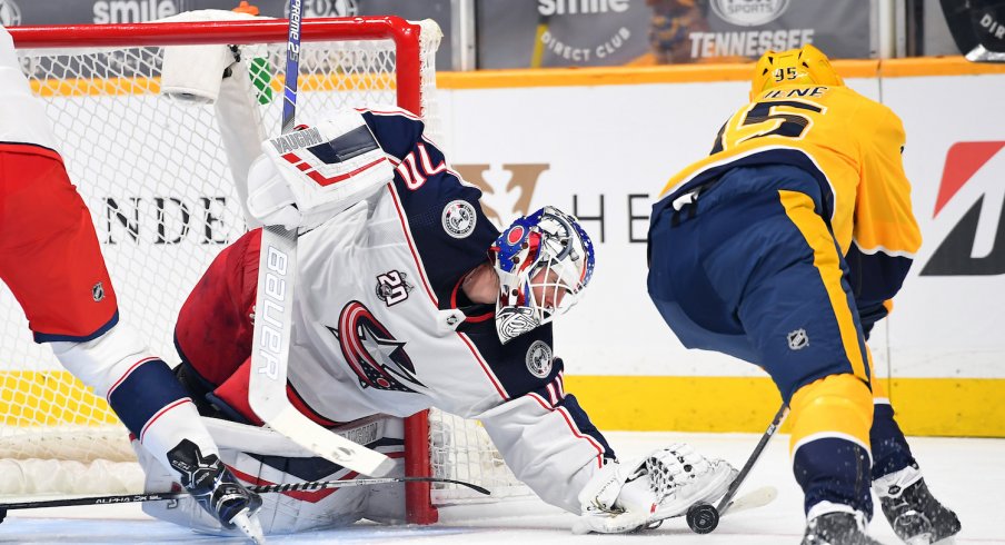 Columbus Blue Jackets goaltender Joonas Korpisalo (70) is unable to take the puck from Nashville Predators center Matt Duchene (95) during the first period at Bridgestone Arena.