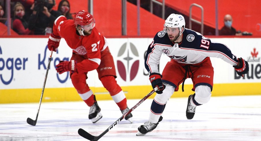 Columbus Blue Jackets center Liam Foudy (19) brings the puck up ice during the third period against the Detroit Red Wings at Little Caesars Arena.