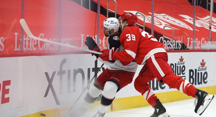 Detroit Red Wings right wing Anthony Mantha (39) checks Columbus Blue Jackets defenseman Vladislav Gavrikov (44) during the second period at Little Caesars Arena.