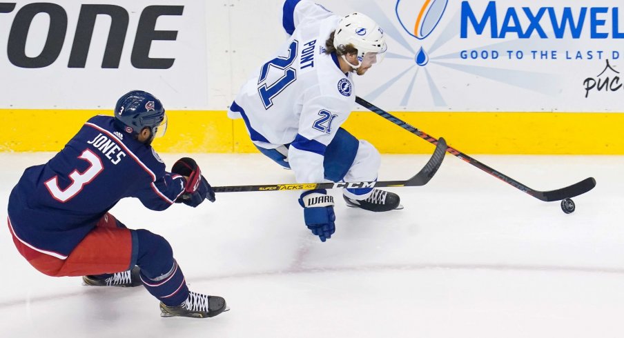 Aug 15, 2020; Toronto, Ontario, CAN; Tampa Bay Lightning center Brayden Point (21) skates with the puck as Columbus Blue Jackets defenseman Seth Jones (3) gives chase during the first period of game three of the first round of the 2020 Stanley Cup Playoffs at Scotiabank Arena.