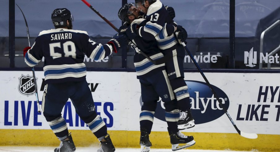 Jan 26, 2021; Columbus, Ohio, USA; Columbus Blue Jackets right wing Cam Atkinson (13) leaps into the arms of left wing Nick Foligno (71) to celebrate scoring a goal against the Florida Panthers in the third period at Nationwide Arena.