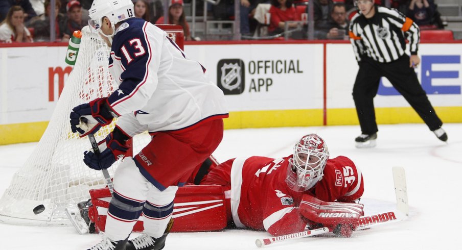 Columbus Blue Jackets forward Cam Atkinson takes a shorthanded shot attempt on Detroit Red Wings goaltender Jimmy Howard.