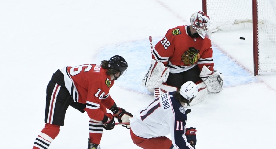 Columbus Blue Jackets center Kevin Stenlund (11) scores a goal on Chicago Blackhawks goaltender Kevin Lankinen (32) during the third period at United Center.