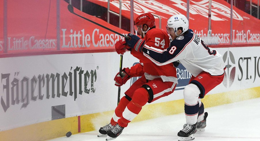 Jan 18, 2021; Detroit, Michigan, USA; Columbus Blue Jackets defenseman Zach Werenski (8) checks Detroit Red Wings right wing Bobby Ryan (54) during the second period at Little Caesars Arena.