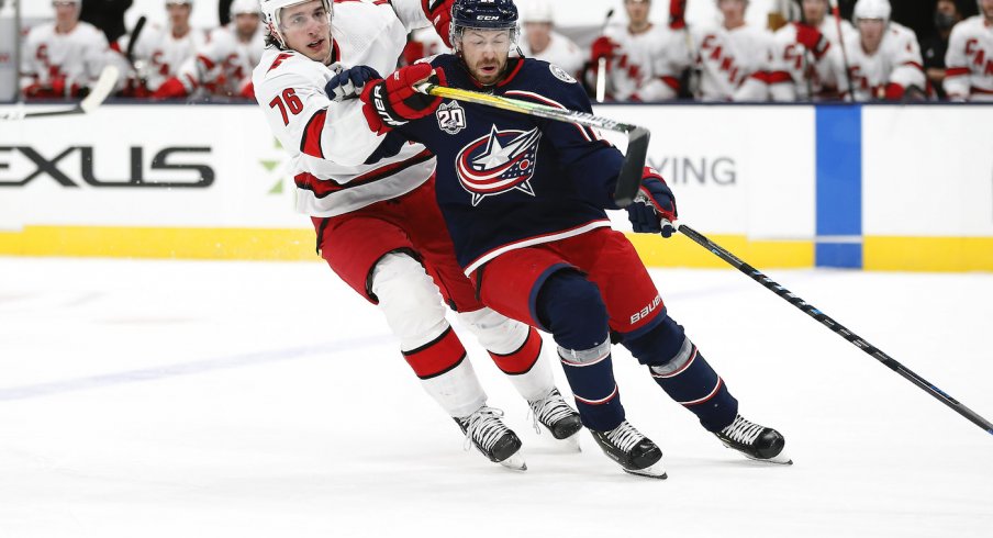 Carolina Hurricanes defenseman Brady Skjei (76) checks Columbus Blue Jackets center Boone Jenner (38) during the first period at Nationwide Arena.