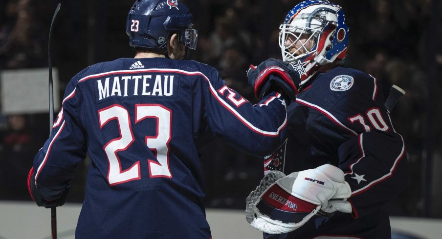 Mar 1, 2020; Columbus, Ohio, USA; Columbus Blue Jackets goaltender Joonas Korpisalo (70) is congratulated by center Stefan Matteau (23) after their win against the Vancouver Canucks at Nationwide Arena.