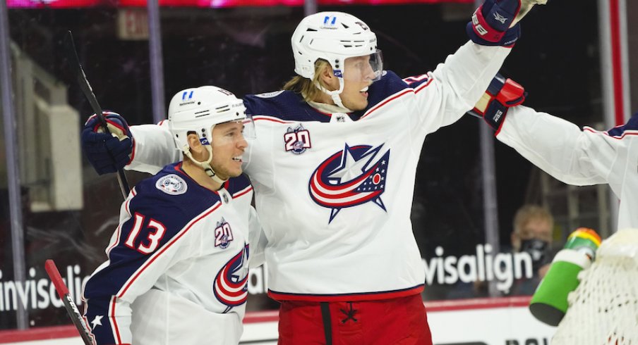 Columbus Blue Jackets right wing Cam Atkinson (13) is congratulated by right wing Patrik Laine (29) after his goal against the Carolina Hurricanes the first period at PNC Arena.