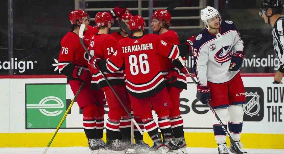 Feb 15, 2021; Raleigh, North Carolina, USA; Carolina Hurricanes left wing Brock McGinn (23) is congratulated by left wing Teuvo Teravainen (86) defenseman Jake Bean (24) right wing Sebastian Aho (20) and defenseman Brady Skjei (76) after his goal against the Columbus Blue Jackets during the third period at PNC Arena.