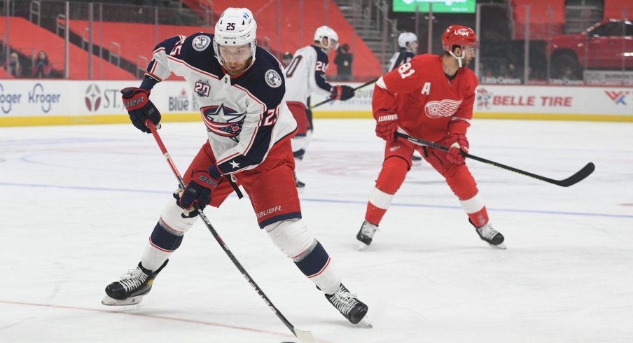 Jan 18, 2021; Detroit, Michigan, USA; Columbus Blue Jackets center Mikhail Grigorenko (25) brings the puck up ice against the Detroit Red Wings during the first period at Little Caesars Arena.