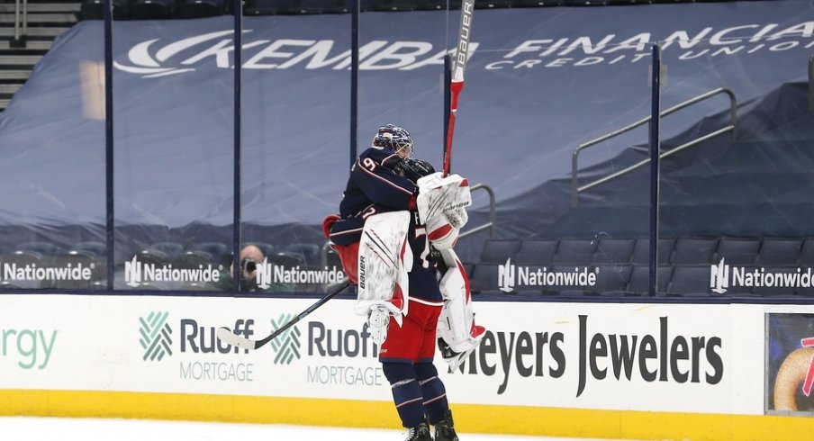 Columbus Blue Jackets goalie Elvis Merzlikins (90) and left wing Nick Foligno (71) celebrate the win after the game against the Nashville Predators at Nationwide Arena.