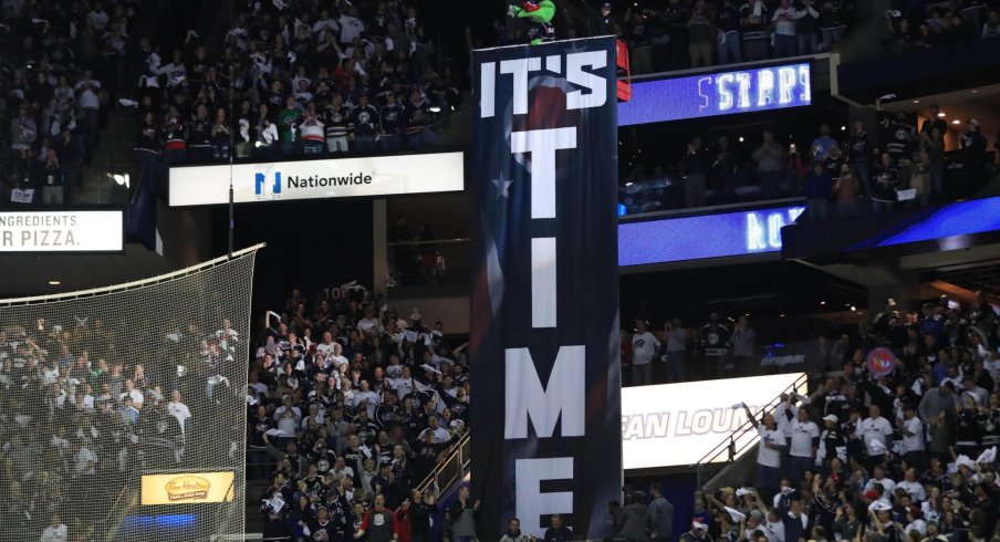 Apr 16, 2019; Columbus, OH, USA; Columbus mascot Stinger stands over the It's Time banner prior to game four of the first round of the 2019 Stanley Cup Playoffs in the game of the Tampa Bay Lightning against the Columbus Blue Jackets at Nationwide Arena.