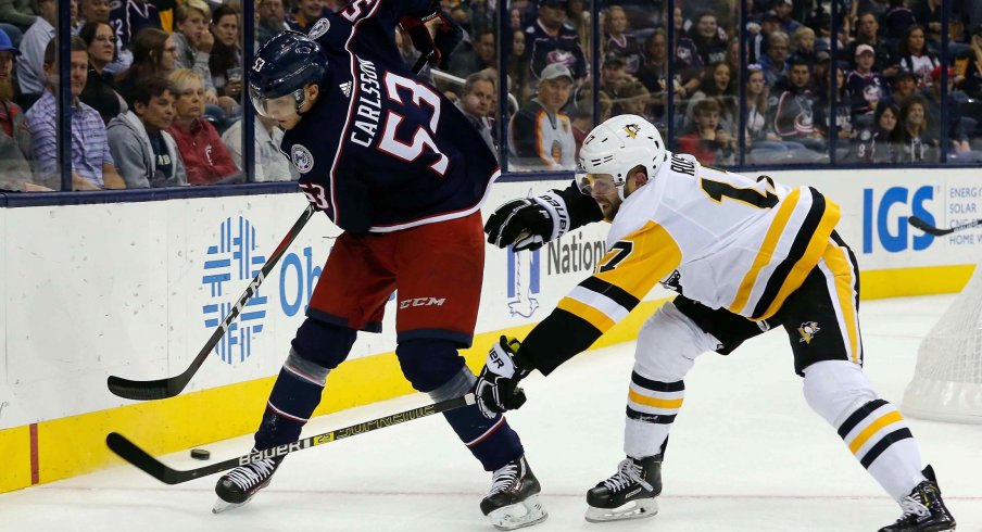 Sep 28, 2018; Columbus, OH, USA; Columbus Blue Jackets defenseman Gabriel Carlsson (53) passes the puck away from Pittsburgh Penguins right wing Bryan Rust (17) during the first period at Nationwide Arena.