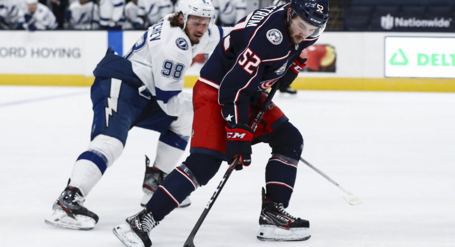 Jan 21, 2021; Columbus, Ohio, USA; Tampa Bay Lightning defenseman Mikhail Sergachev (98) skates as Columbus Blue Jackets center Emil Bemstrom (52) controls the puck at Nationwide Arena.