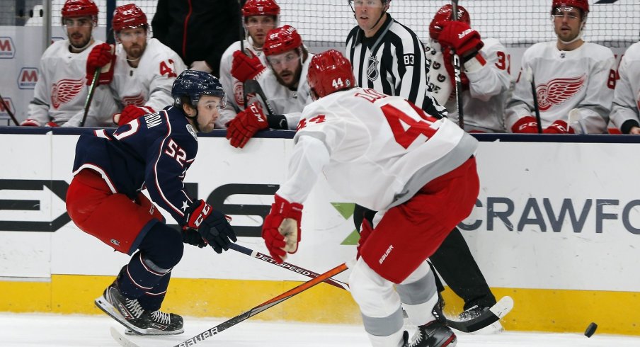 Columbus Blue Jackets center Emil Bemstrom (52) moves the puck past Detroit Red Wings center Darren Helm (43) during the first period at Nationwide Arena.