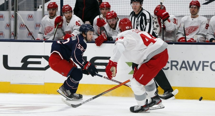 Columbus Blue Jackets center Emil Bemstrom (52) moves the puck past Detroit Red Wings center Darren Helm (43) during the first period at Nationwide Arena.