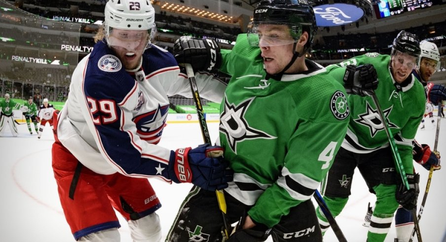 Columbus Blue Jackets right wing Patrik Laine (29) and Dallas Stars defenseman Miro Heiskanen (4) fight for the puck during the third period at the American Airlines Center.