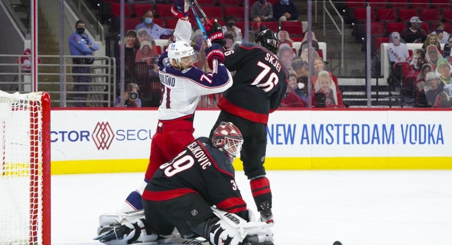 Carolina Hurricanes goaltender Alex Nedeljkovic (39) with defenseman Brady Skjei (76) turns the shot away from Columbus Blue Jackets left wing Nick Foligno (71) during the first period at PNC Arena. 