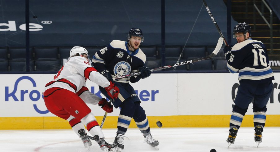 Columbus Blue Jackets forward Max Domi fights for the puck against the Carolina Hurricanes at Nationwide Arena.