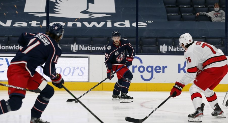 Columbus Blue Jackets right wing Oliver Bjorkstrand (28) looks to pass as Carolina Hurricanes defenseman Brady Skjei (76) defends during the first period at Nationwide Arena.