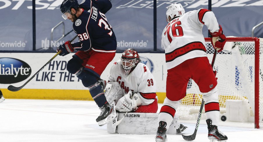 Columbus Blue Jackets forward Boone Jenner competes for the puck against Brady Skjei of the Carolina Hurricanes at Nationwide Arena.