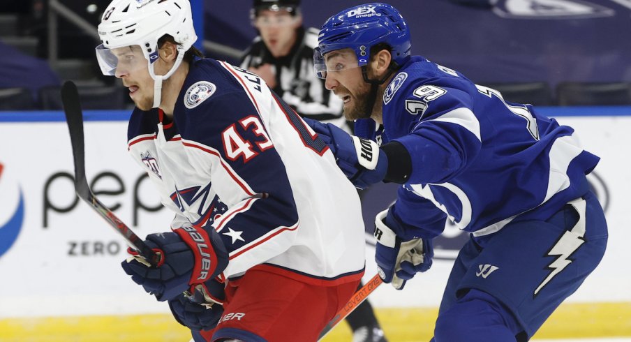 Columbus Blue Jackets defenseman Mikko Lehtonen (43) and Tampa Bay Lightning right wing Barclay Goodrow (19) skate after the puck during the first period at Amalie Arena.