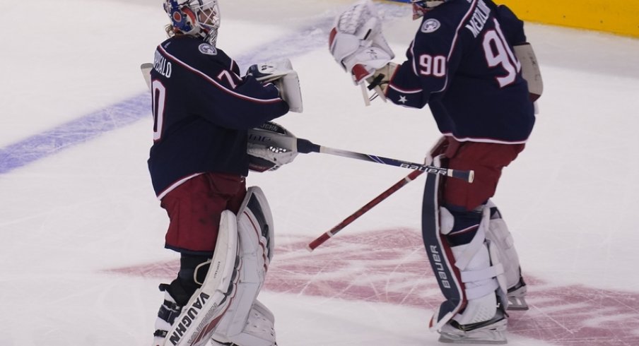 Columbus Blue Jackets goaltender Joonas Korpisalo (70) heads for the bench as he is replaced by goaltender Elvis Merzlikins (90) during the second period against the Toronto Maple Leafs in the Eastern Conference qualifications at Scotiabank Arena. 