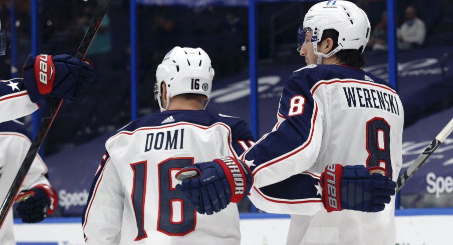 Columbus Blue Jackets defenseman Zach Werenski (8) is congratulated as he scores a goal against the Tampa Bay Lightning during the second period at Amalie Arena.