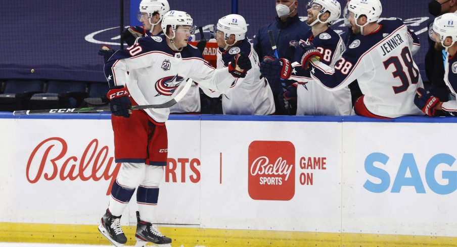 Apr 1, 2021; Tampa, Florida, USA; Columbus Blue Jackets left wing Eric Robinson (50) is congratulated as he scores a goal against the Tampa Bay Lightning during the third period at Amalie Arena.