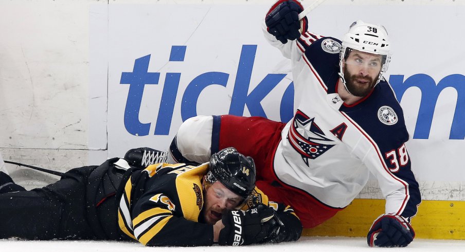 Columbus Blue Jackets forward Boone Jenner competes for the puck against Brady Skjei of the Carolina Hurricanes at Nationwide Arena.