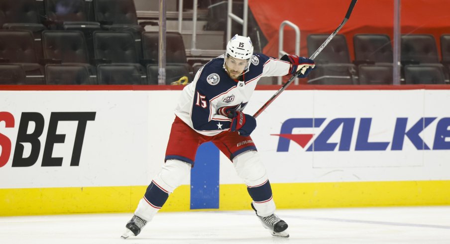 Columbus Blue Jackets defenseman Michael Del Zotto (15) takes a shot in the first period against the Detroit Red Wings at Little Caesars Arena