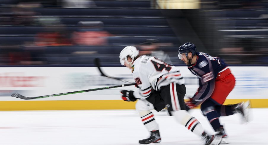 Chicago Blackhawks defenseman Wyatt Kalynuk (48) skates against Columbus Blue Jackets left wing Stefan Matteau (23) for the loose puck in the first period at Nationwide Arena. 