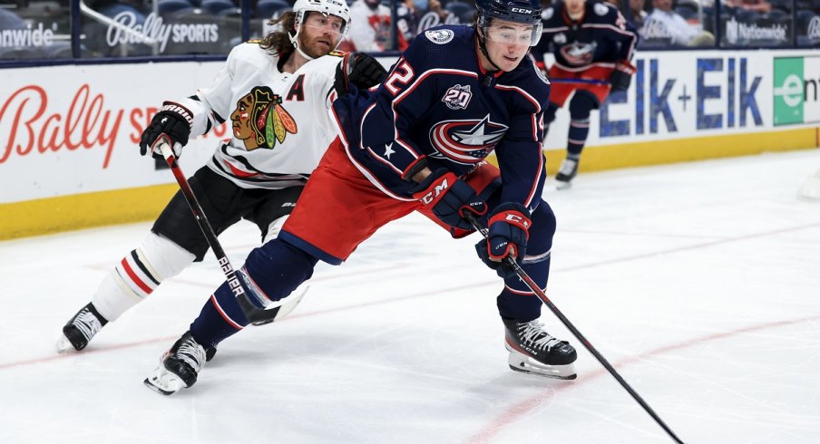 Alexandre Texier controls the puck against Duncan Keith