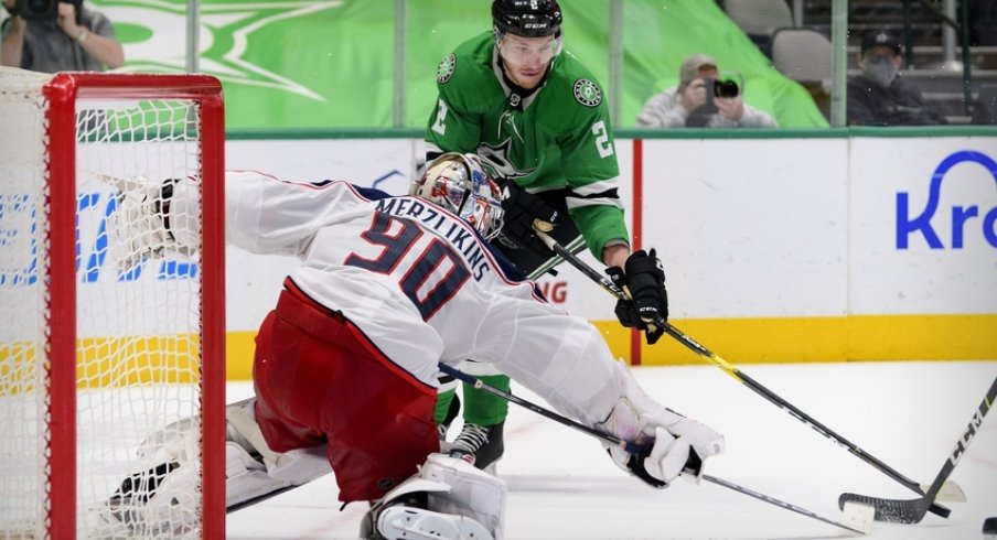 Columbus Blue Jackets goaltender Elvis Merzlikins (90) stops a shot by Dallas Stars defenseman Jamie Oleksiak (2) during the second period at the American Airlines Center.