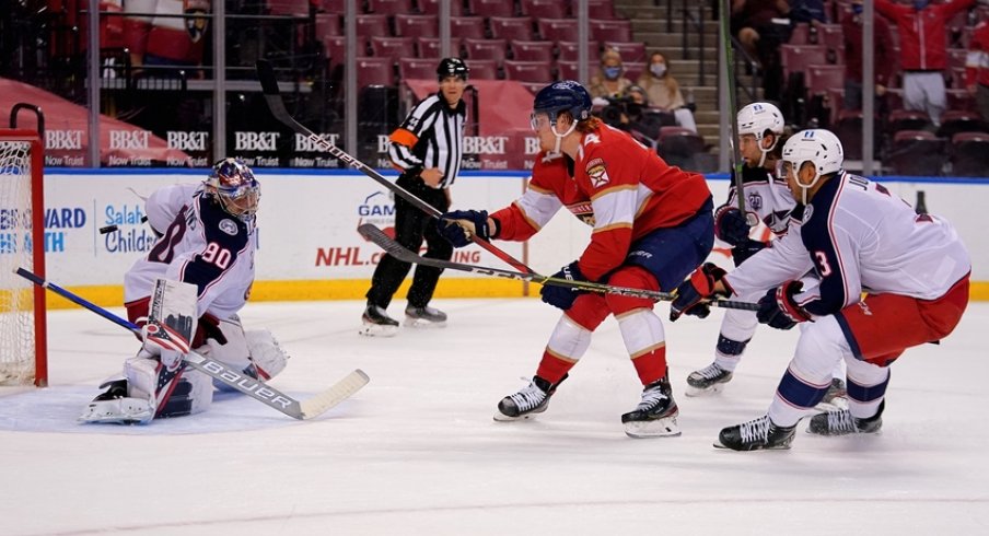 Columbus Blue Jackets goaltender Elvis Merzlikins (90) blocks the shot of Florida Panthers right wing Owen Tippett (74) during the second period at BB&T Center. 