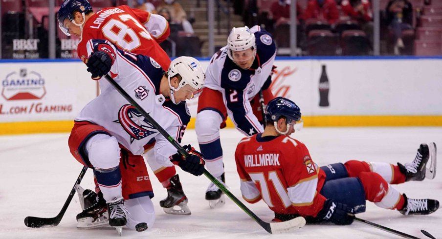 Apr 19, 2021; Sunrise, Florida, USA; Columbus Blue Jackets center Josh Dunne (21) blocks the puck against the Florida Panthers during the second period at BB&T Center.