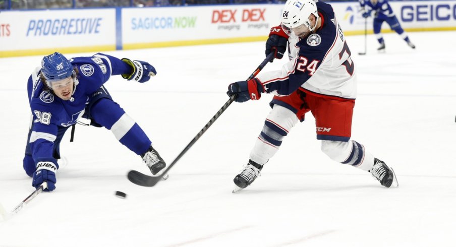 Columbus Blue Jackets left wing Nathan Gerbe (24) passes the puck as Tampa Bay Lightning defenseman Mikhail Sergachev (98) during the second period at Amalie Arena.